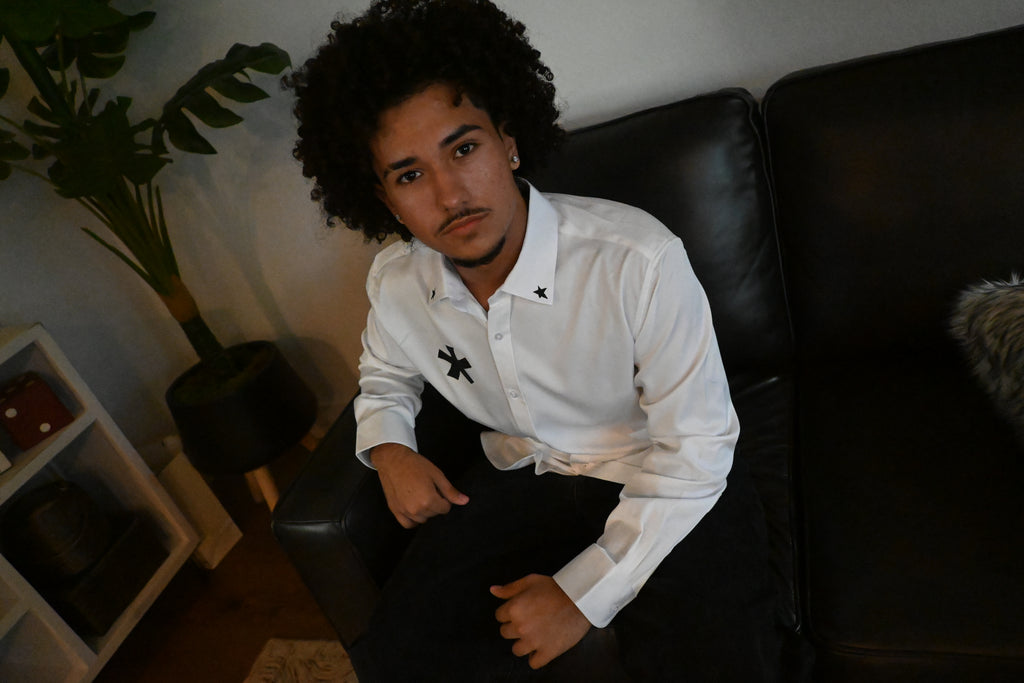 A white button up with stars on the collar and front, as well as a cybersigilism design on the back.