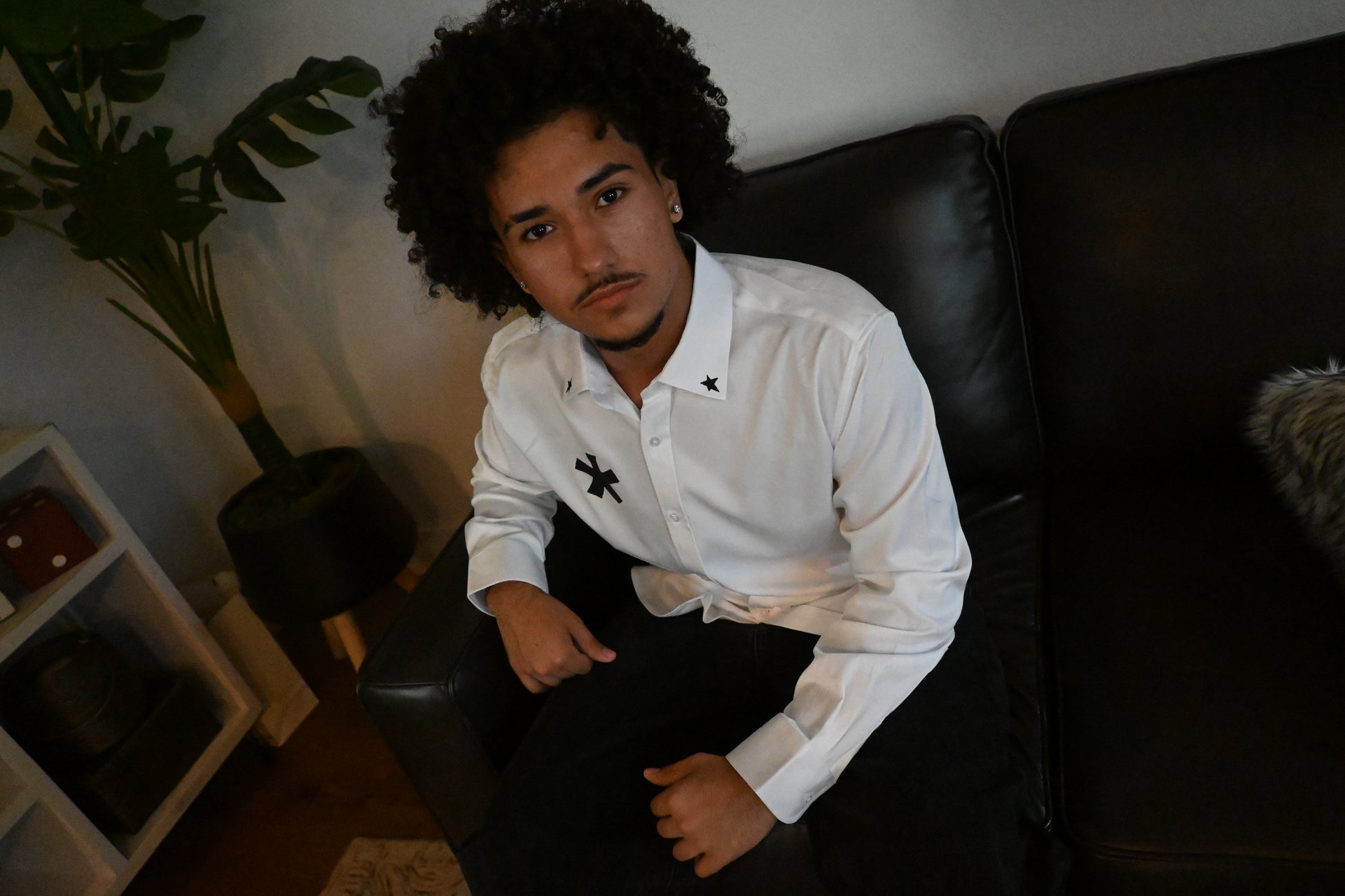 A white button up with stars on the collar and front, as well as a cybersigilism design on the back.