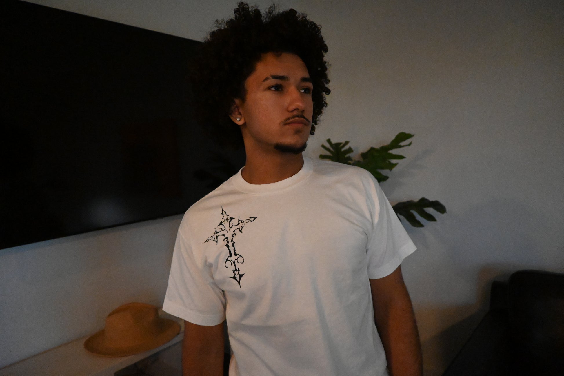 A hand painted white t-shirt with a black cross design.