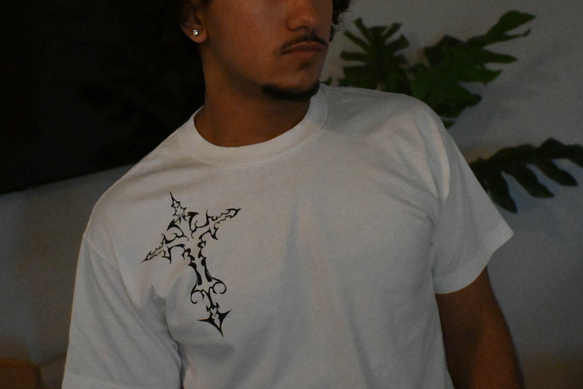 A hand painted white t-shirt with a black cross design.