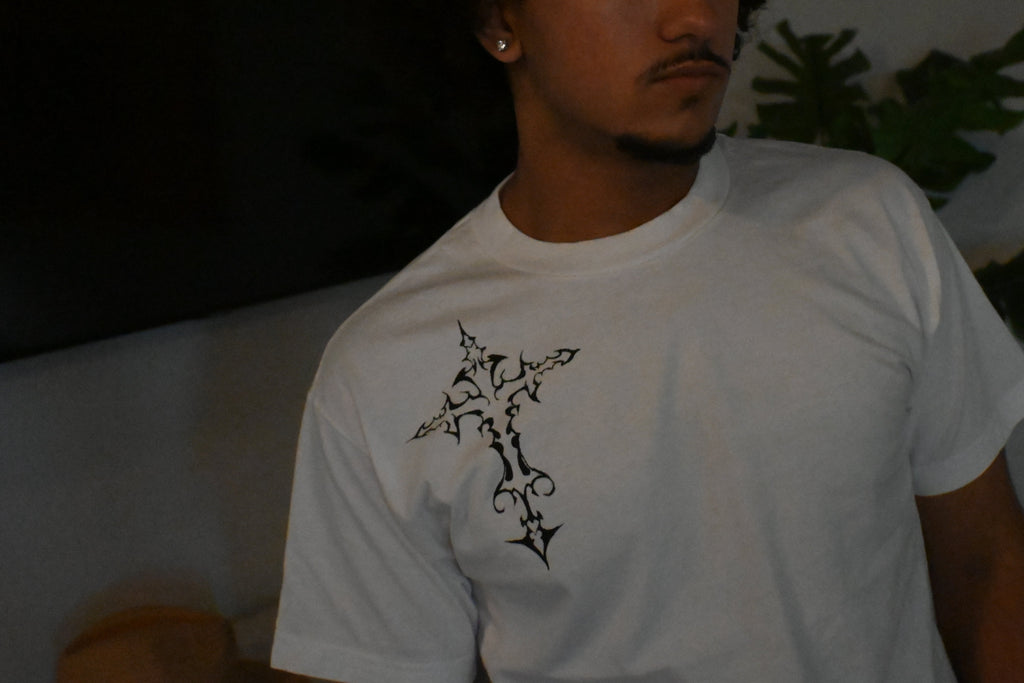 A hand painted white t-shirt with a black cross design.