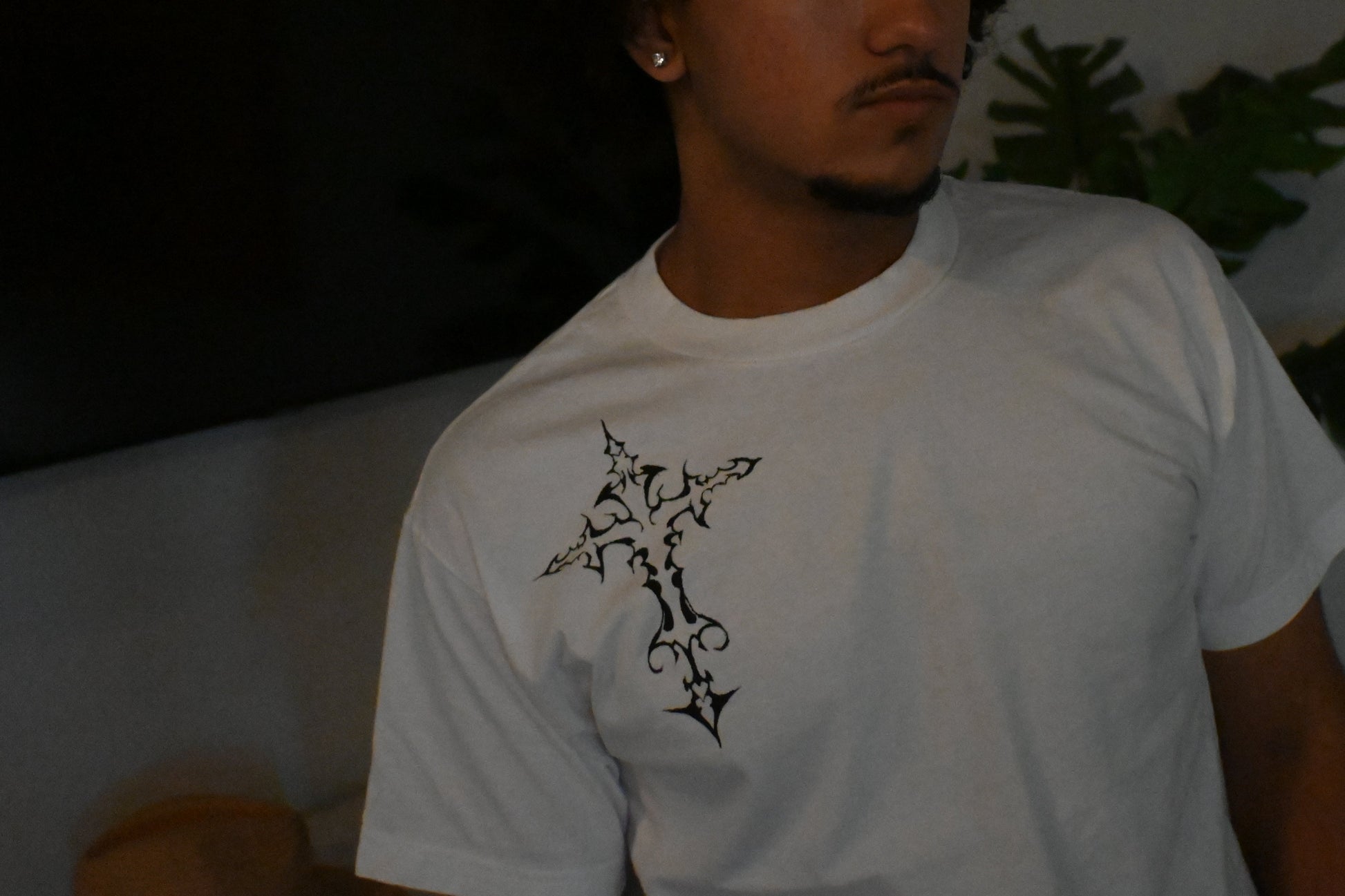 A hand painted white t-shirt with a black cross design.
