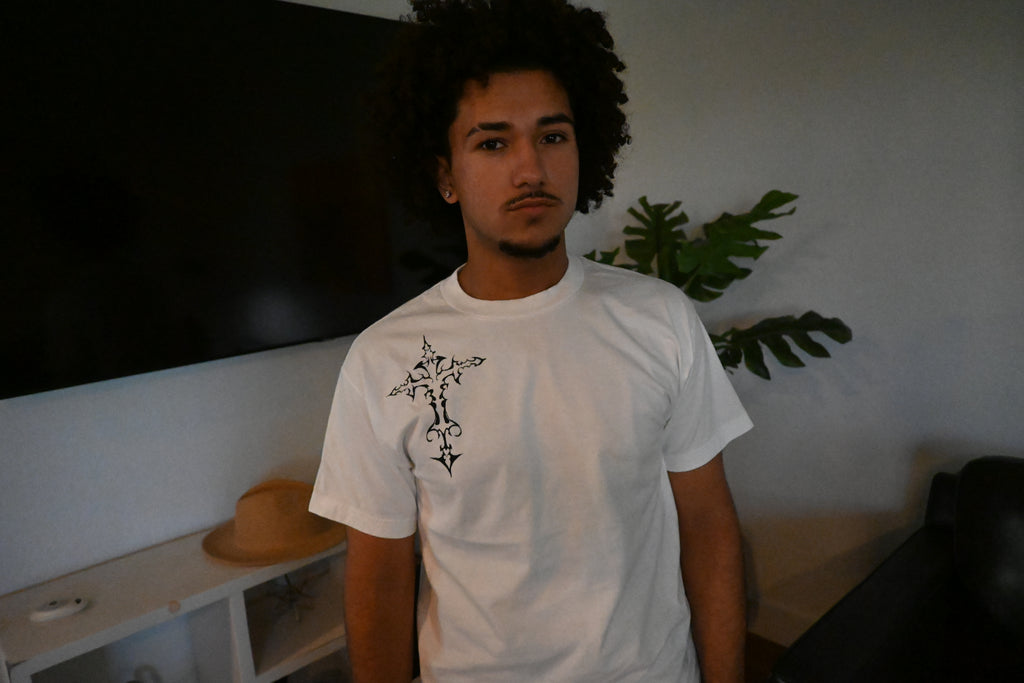 A hand painted white t-shirt with a black cross design.
