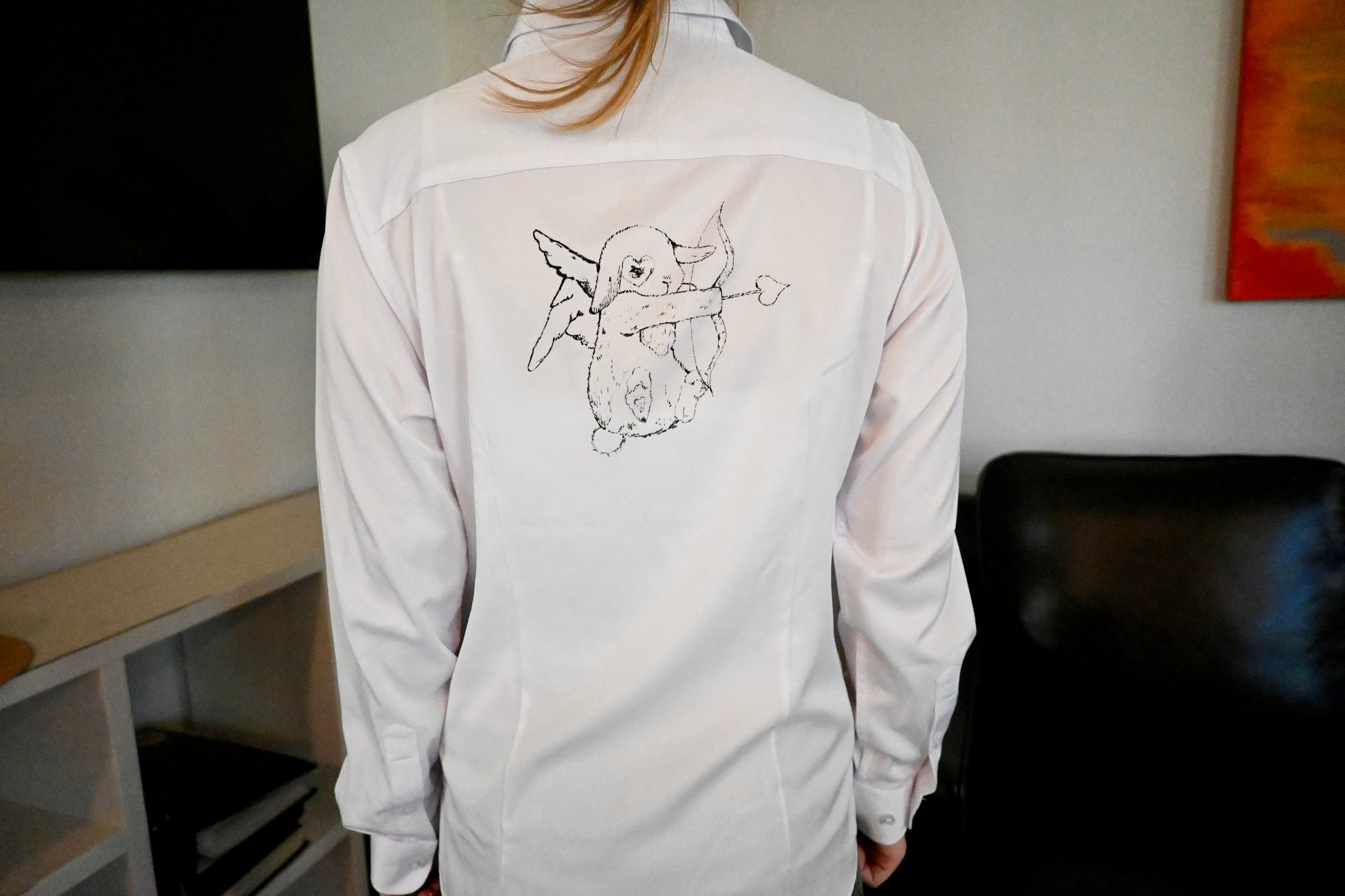 A hand painted shirt with a blue bunny design.