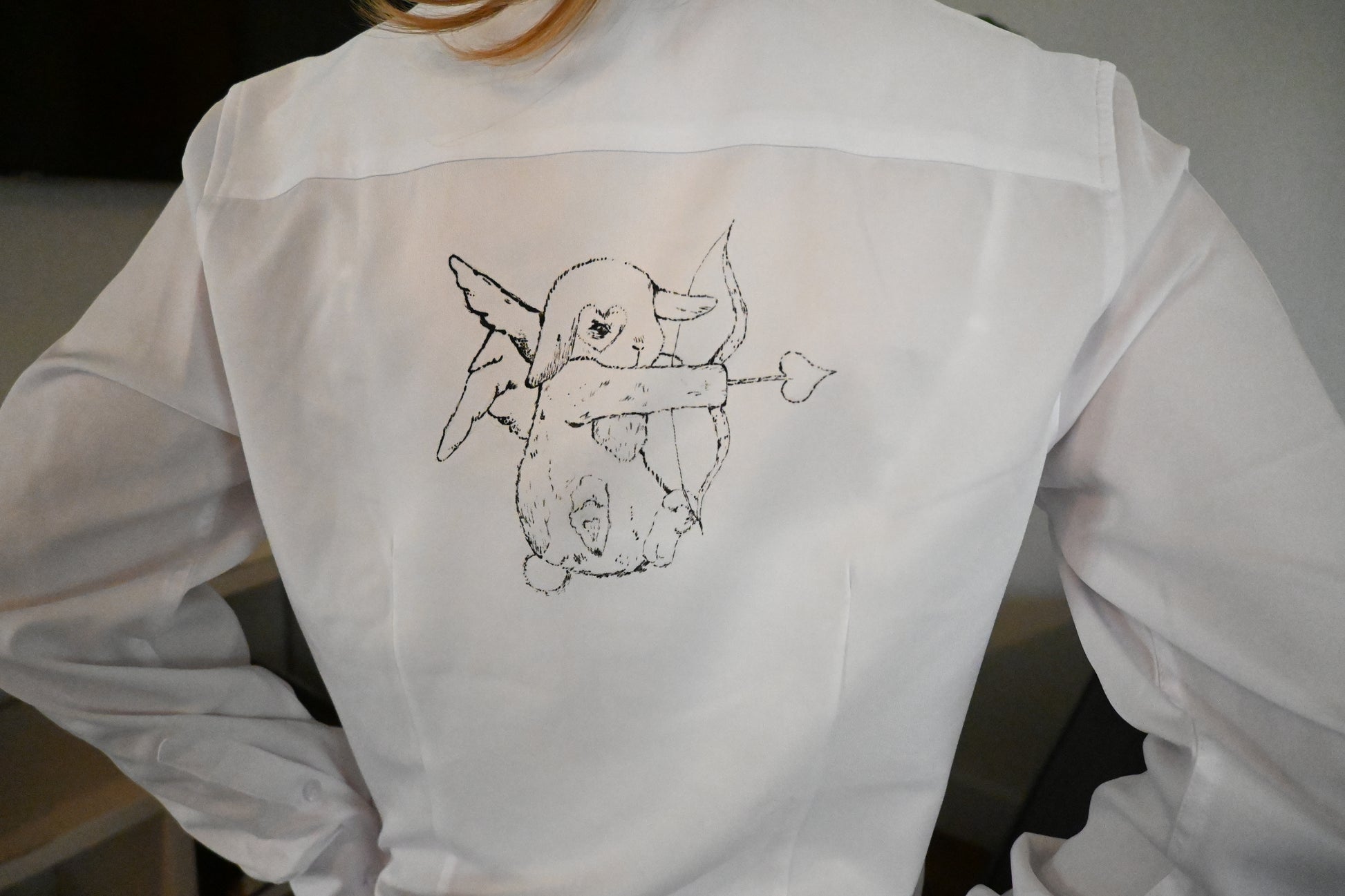 A hand painted shirt with a blue bunny design.