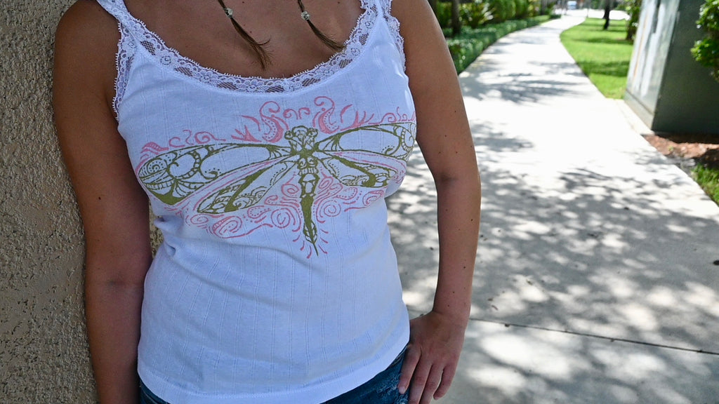 A hand painted lace tank top with a green dragonfly design and pink accents.