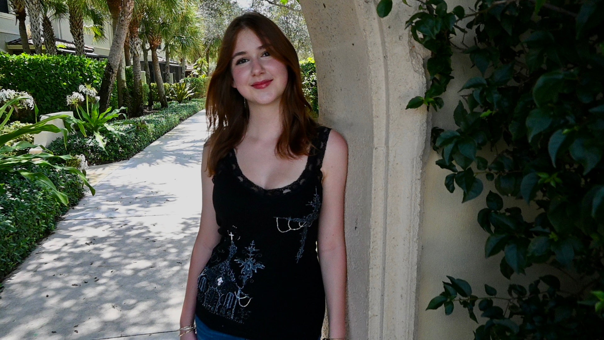 A hand painted lace tank top with a church and cross design.