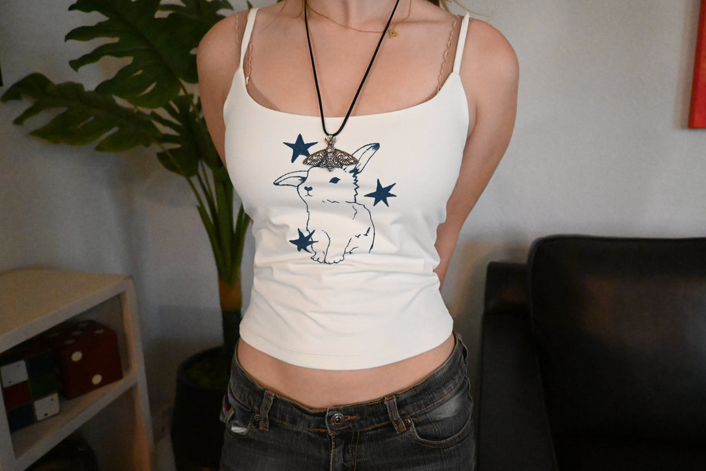 A hand painted shirt with a blue bunny design.