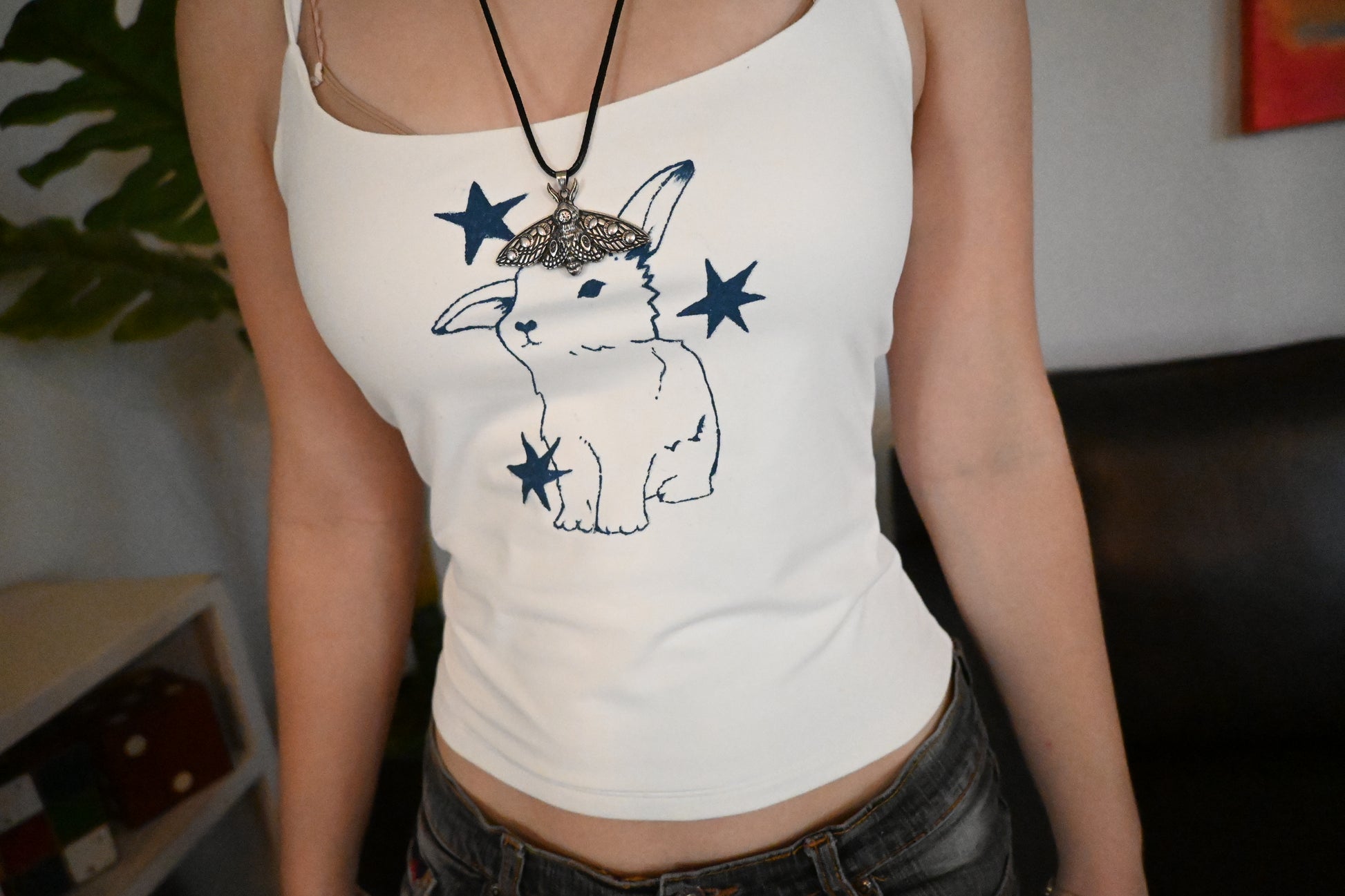 A hand painted shirt with a blue bunny design.